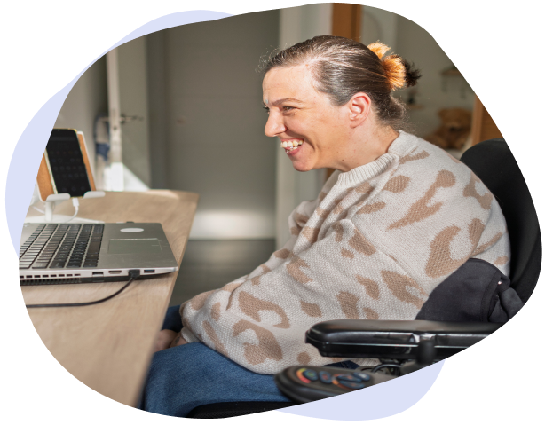 A woman with an aquired brain injury uses physiotherapy to help her work at her computer