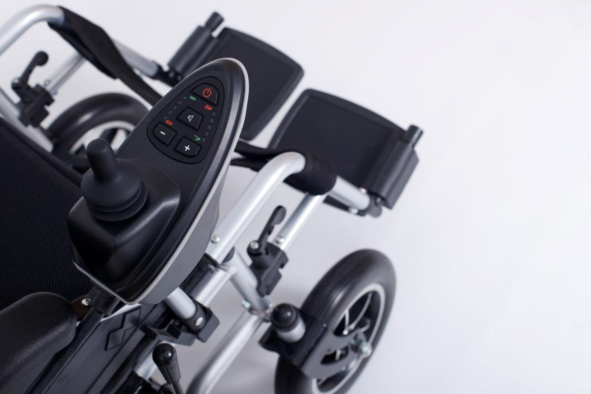 Wheelchair with controller including joystick and buttons