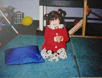 Dianna as a toddler playing on the mat