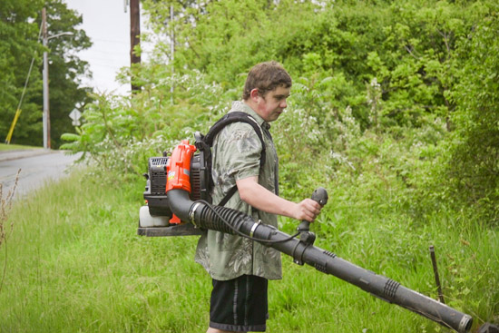 ethan operating a leaf blower