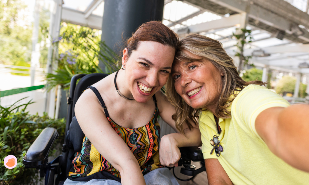 A person with disability is smiling with her carer.