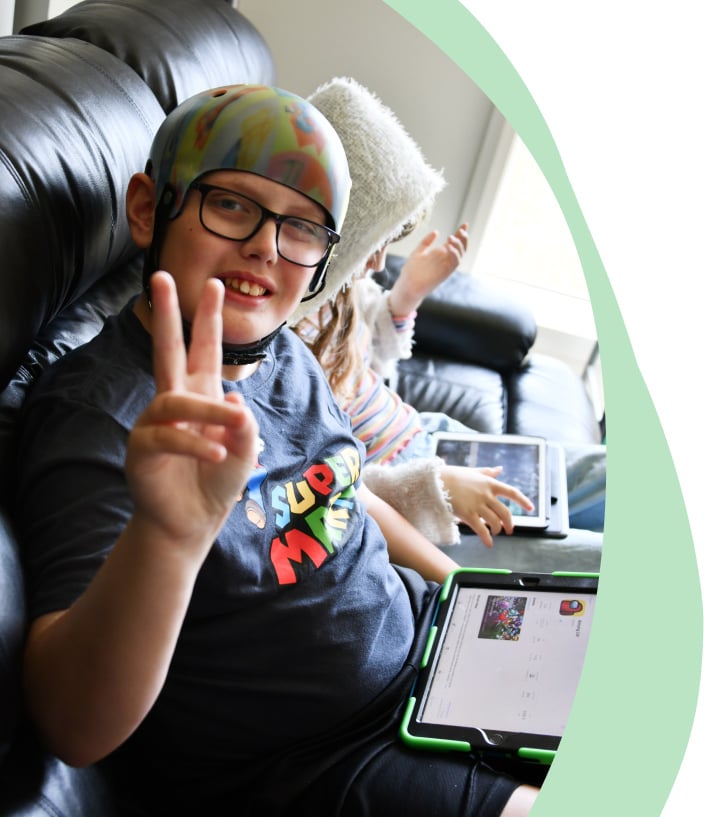 a boy with autism showing v sign mycarespace