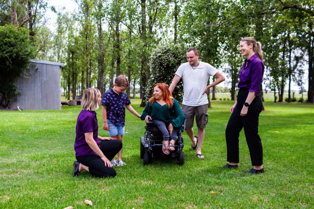 A person in a wheelchair talking with her occupational therapist during a therapy session.A person in a wheelchair talking with her occupational therapist during a therapy session.