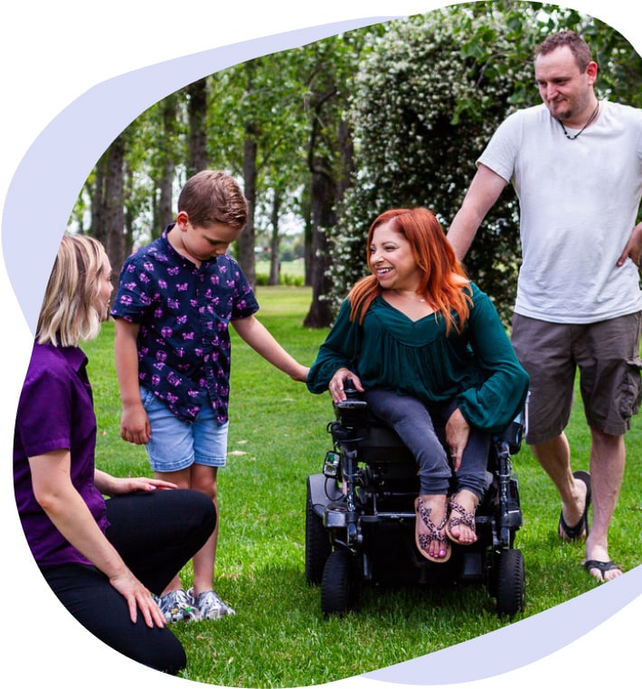 A person in a wheelchair talking with an occupational therapist.