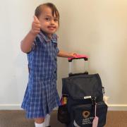 MAia standing with her school bag