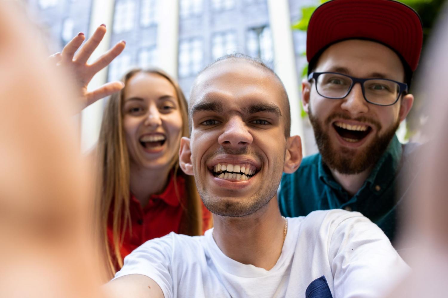 Person with disability and support workers taking a photo together