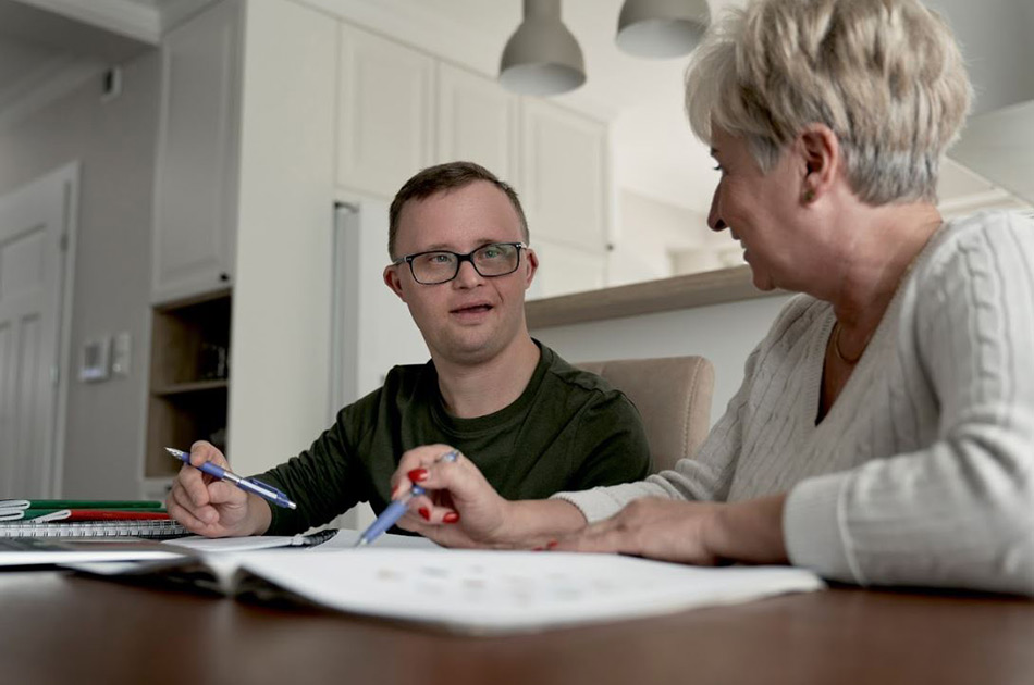 Young man with a woman sitting at a desk