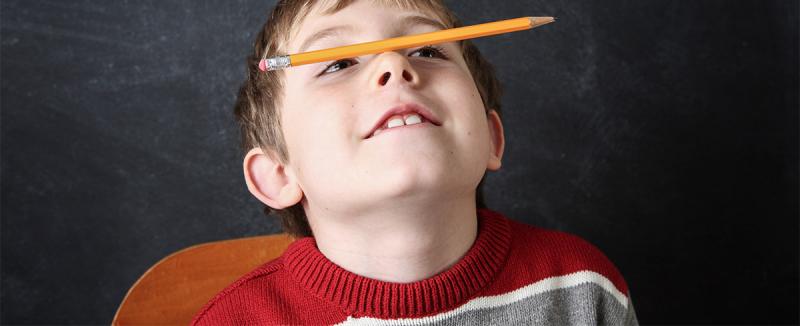 boy with pencil on his nose