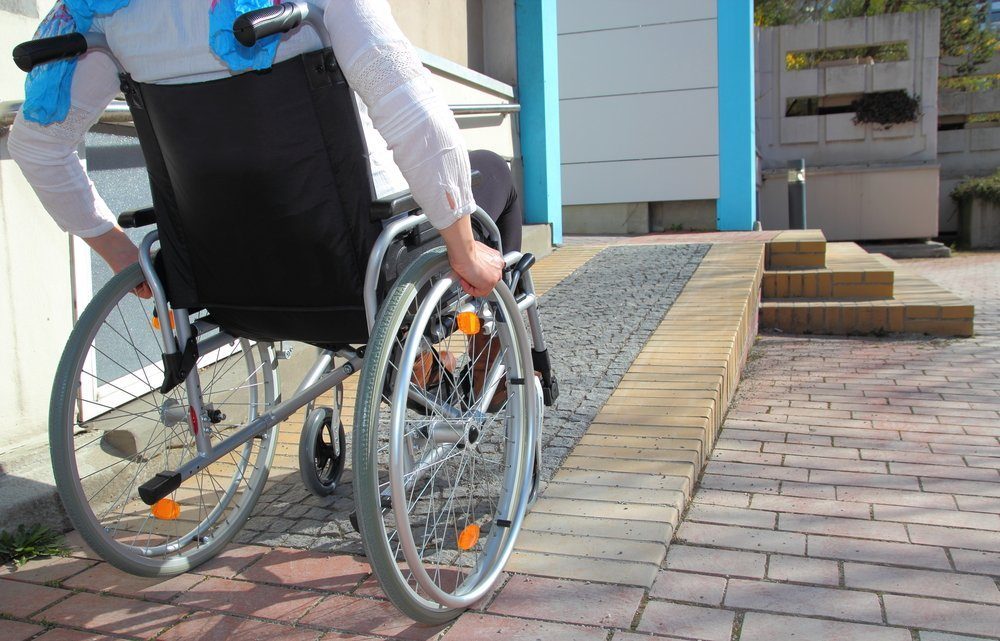 Person in a whelchair traversing a ramp at home