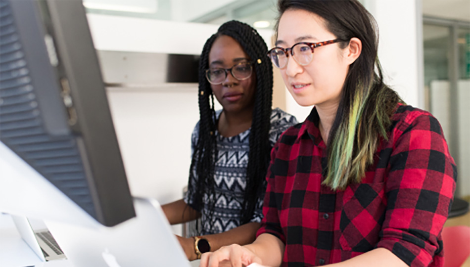 Two people in front of a computer