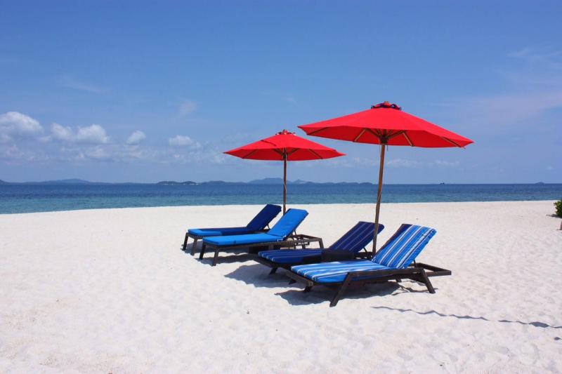 blue beach chairs on a white beach