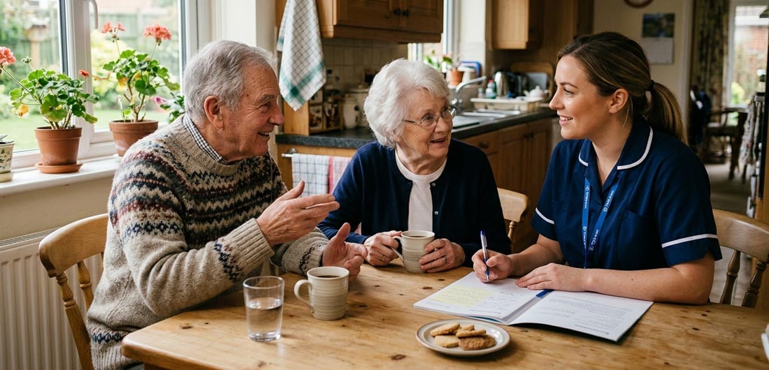 An older couple sitting at the kitchen table interviewing a My Aged Care provider