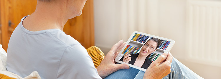 Person using ipad to receive teletherapy