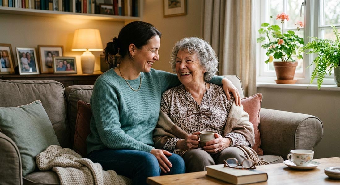 A young woman with her arm around her elderly mother
