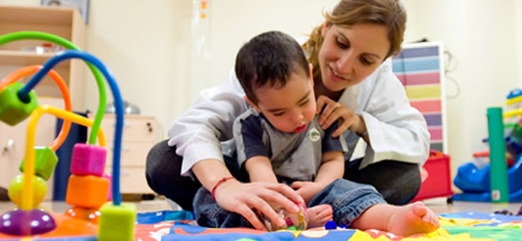 occupational therapist with a young boy