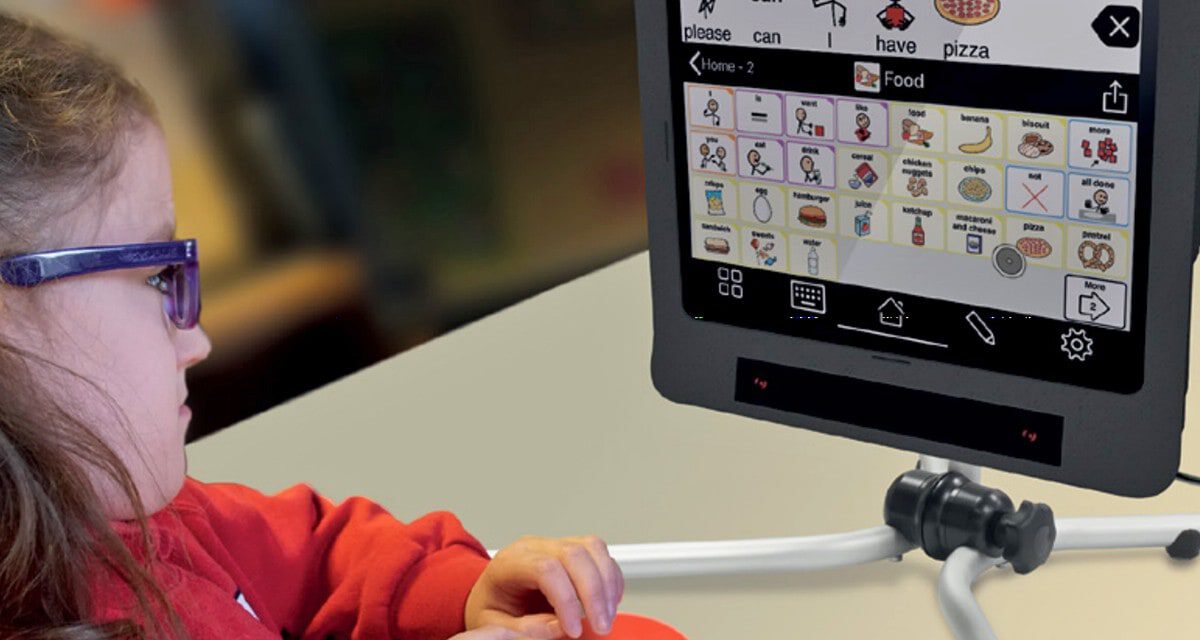 Young girl sitting in front of an assistive technology screen