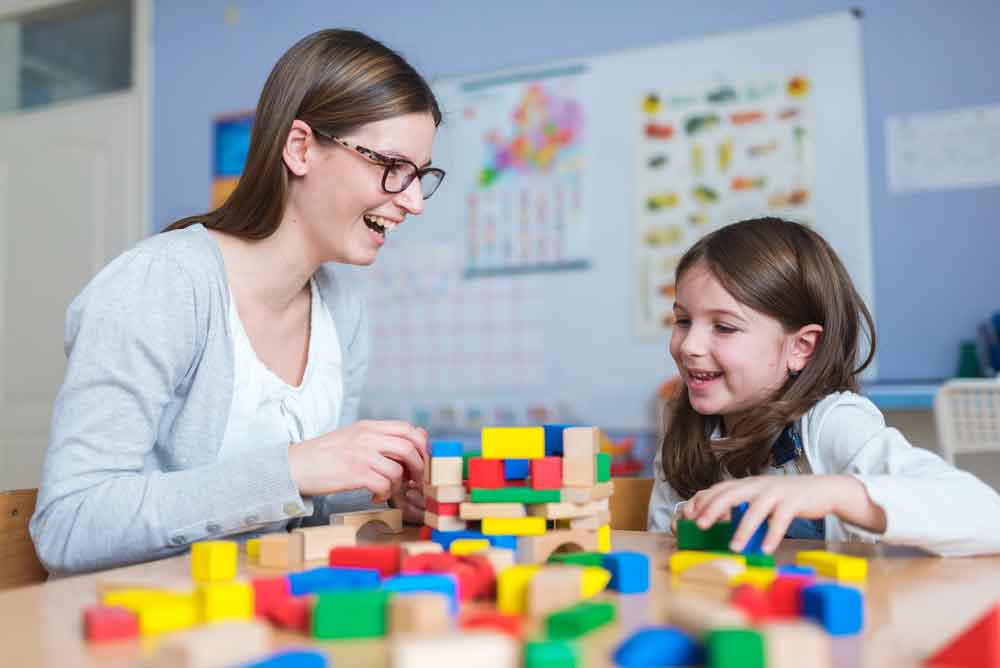 An OT with a child using large lego blocks