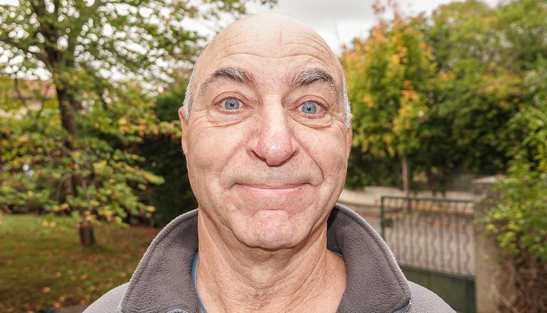 An older man who has been garden is surprised with a photo