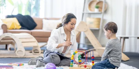 a child attending ot session with parent online