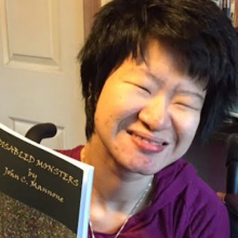 Erin Kelly smiling while holding one of her books