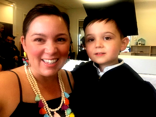 Emily smiling with Ollie at Graduation