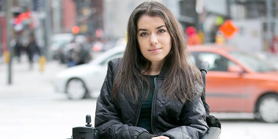 Maayan Ziv poses in front of an urban backdrop