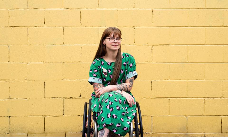 Nicole Lee in front of a yellow wall