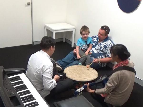 Darcy sitting on his fathers lap in the music lab