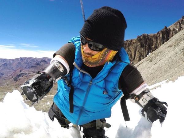 Kyle Maynard climbing up a snow covered mountain